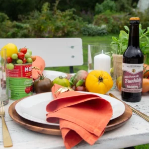 Table decoration with colourful tomatoes and herbs for an Italian party