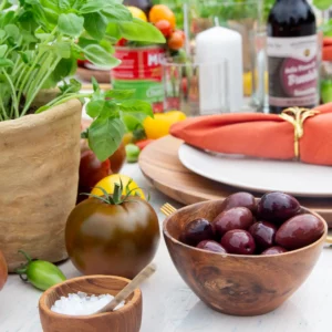 Olives in a rustic wooden bowl as table decoration for an Italian garden party