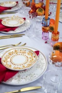Hand-painted plate on white linen tablecloth with berry decoration.
