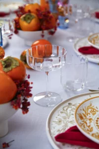 Elegant glasses from the Jazz collection, surrounded by fruit decorations.