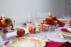 YOKI vase with persimmon and red berries, embedded in a maximalist table decoration.