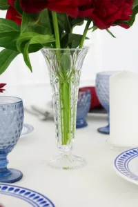 Close-up of red peonies in a crystal vase.