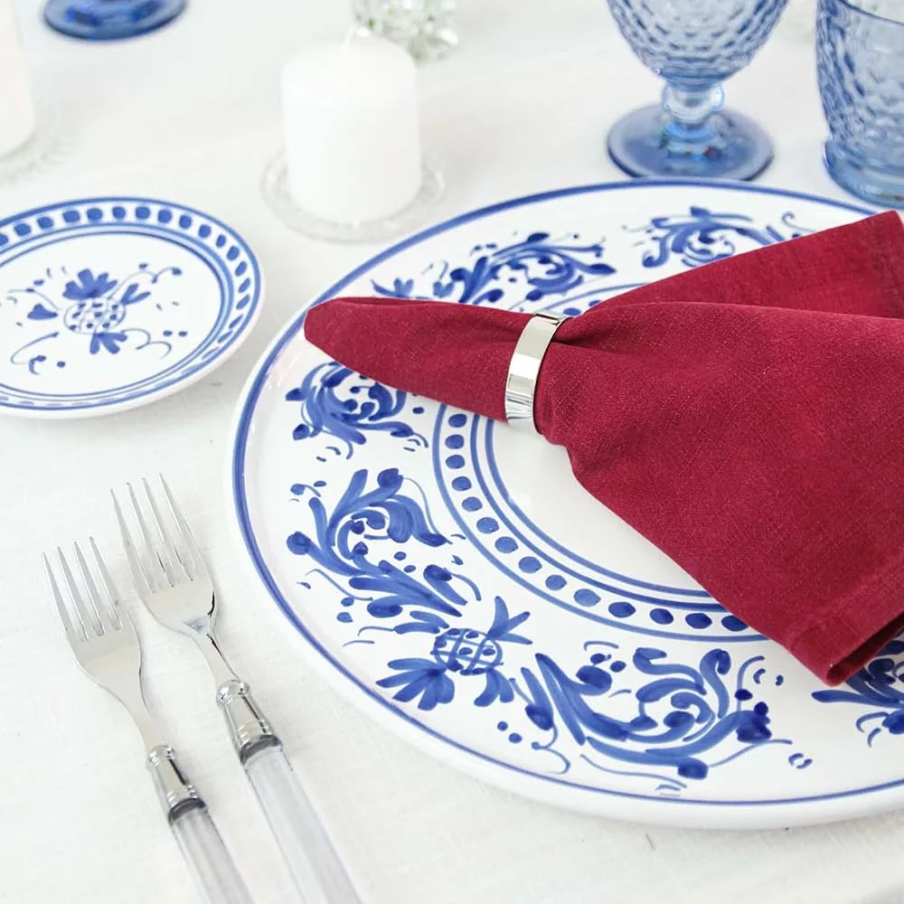 magnolias-on-silk-table-of-the-month-mai-peony-red-blue-table-inspiration-28-square Adelasia Blu place mat, wine-red linen napkin and Doric Clear cutlery set on a white tablecloth.